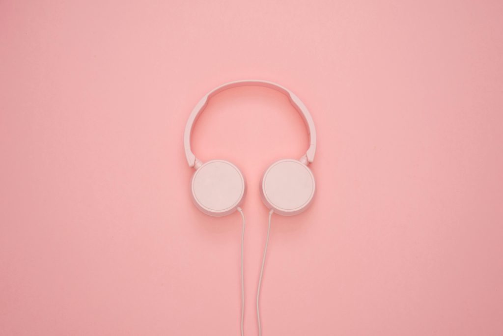 Aesthetic pink headphones on a pastel background, perfect for a modern and stylish look.